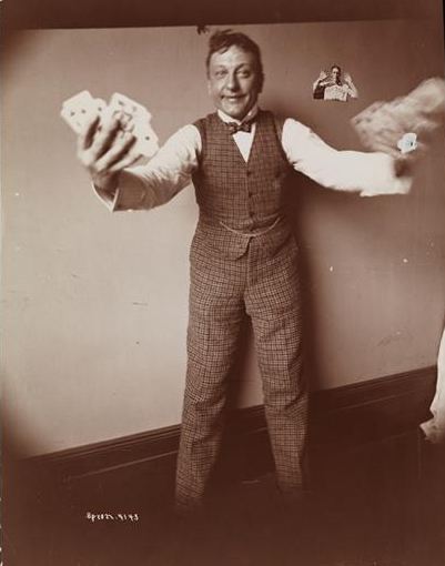 Henry Dixey playing a card trick, around 1900.