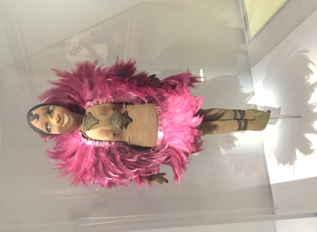 A doll showing Josephine Baker in pink feathers, as seen in "Le Modèle Noir" at the Orsay Museum 2019.