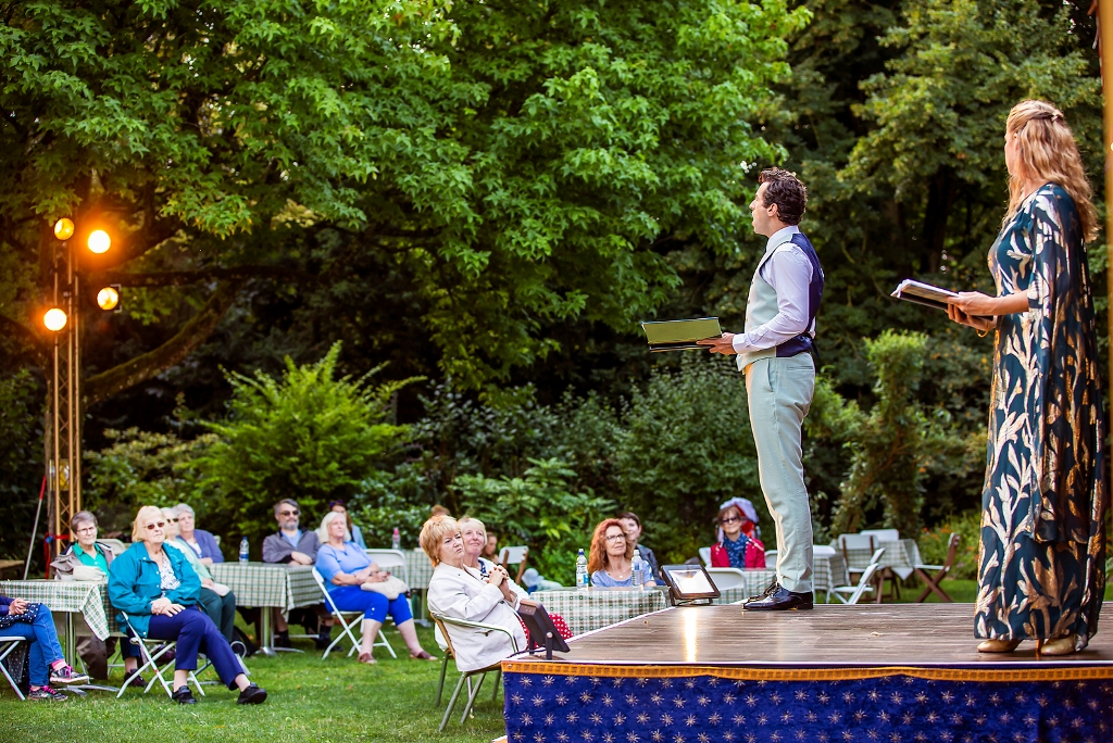 The audience watching "Camelot" being performed in a garden setting. (Photo: Pamela Raith Photography)